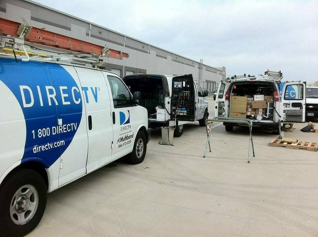 The snapshot showcases our competent team in the midst of replacing front windshields on five DirecTV fleet vans. These company vehicles, stationed in a vast parking lot at the DirecTV site in Monte Vista, Texas, encountered windshield damage from flying road debris during service calls, thereby requiring full replacements. The scene reflects our commitment to delivering timely and proficient service for commercial fleet vehicles.