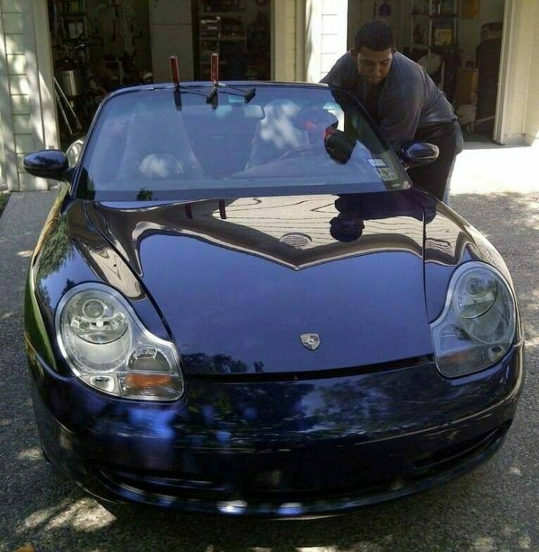 A 2012 dark blue Porsche Boxster is undergoing a front windshield replacement by a highly trained technician. The sedan is being serviced during a home auto glass appointment in the upscale neighborhood of La Cantera, located in San Antonio, Texas.
